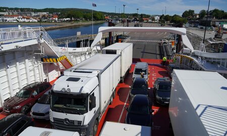 A selection of cars and lorries loading onto a ferry.